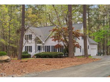 Inviting two-story home features a well-manicured front yard and a classic architectural style at 537 Chatham Dr, Chapel Hill, NC 27516