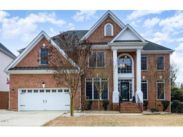 Elegant brick home with a classic facade and welcoming front entrance with white columns at 6020 Jones Farm Rd, Wake Forest, NC 27587