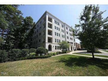 Beautiful low angle exterior of building with well-manicured lawn and greenery at 620 Wade Ave # 206, Raleigh, NC 27605