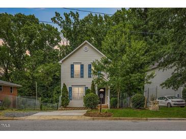 Charming two-story home featuring blue shutters and mature landscaping at 708 Brye St, Durham, NC 27703