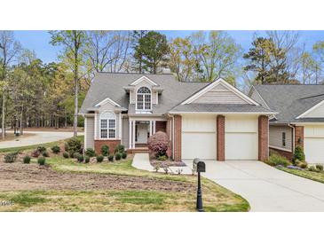 Charming home with well-manicured lawn, two-car garage, and mature trees at 76501 Rice, Chapel Hill, NC 27517