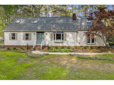 Charming single-story home featuring a brick foundation and a well-manicured front lawn at 8008 Hollander Pl, Raleigh, NC 27606
