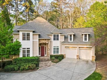 Charming home with a stone entryway, complemented by a manicured lawn and an attached two-car garage at 10370 Spaight, Chapel Hill, NC 27517