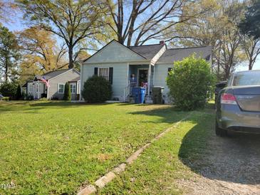 Charming one-story home featuring a spacious lawn, mature trees, and an inviting front porch at 109 Plainview Ave, Raleigh, NC 27604