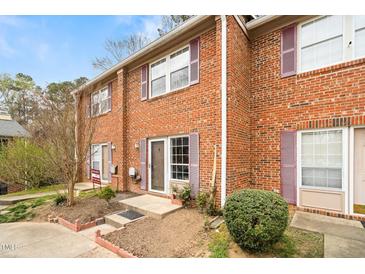 Charming brick townhome displaying purple shutters and well-maintained landscaping at 116 Marlowe Court Ct, Carrboro, NC 27510