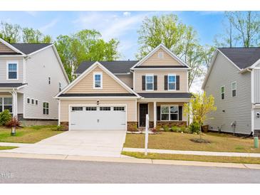 Inviting two-story home boasts a two-car garage, charming exterior, and well-manicured lawn at 270 Trailing Bluff Way, Garner, NC 27529