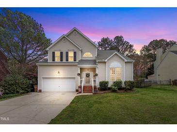Charming two-story home with mature trees, attached garage, and well-manicured lawn at 2832 Steeple Run Dr, Wake Forest, NC 27587