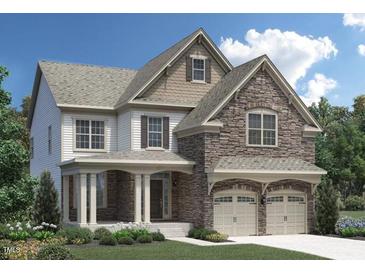 Charming two-story home featuring stone accents, a covered porch, and a two-car garage at 337 Parlier Dr, Cary, NC 27519