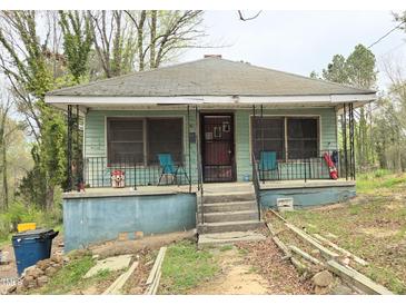 Charming home featuring a quaint front porch and a classic roofline, presenting a cozy curb appeal at 537 Homeland Ave, Durham, NC 27707