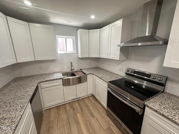 This kitchen features new stainless steel appliances, granite countertops, and white shaker cabinets at 905 Ardmore Dr, Durham, NC 27713