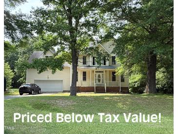 Charming two-story home with attached garage, classic white trim, and inviting front porch at 1623 Rogers Pointe Ln, Creedmoor, NC 27522