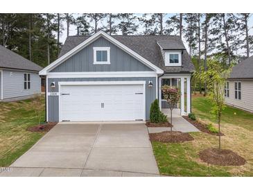 Charming home showcasing a gray exterior, white trim, and a two-car garage at 2304 Beeblossom Pl, Fuquay Varina, NC 27526