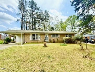 Charming single-story home featuring a covered carport and a well-maintained front yard at 2501 Landis Dr, Durham, NC 27705