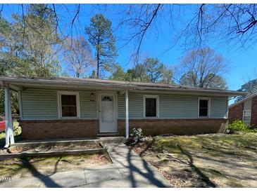 Charming single-story home featuring a brick foundation, light green siding, and a welcoming front entrance at 529 Solar Dr Dr, Raleigh, NC 27610