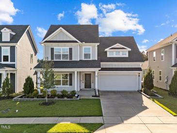 Charming two-story home with a well-manicured lawn and attached two car garage at 6 S Summerhill Rdg, Clayton, NC 27520