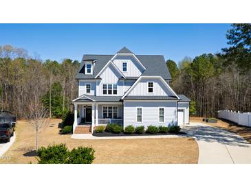 Charming two-story home with manicured lawn, attractive landscaping, and a beautiful, classic architectural design at 609 Meyers Place Ln, Holly Springs, NC 27540