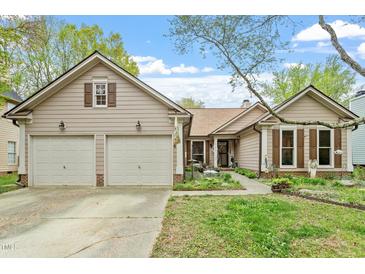 Charming home featuring a two-car garage, complemented by well-maintained landscaping and a welcoming entrance at 11821 Fairlie Pl, Raleigh, NC 27613