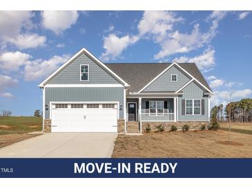 Charming home showcases a two-car garage, stone accents, and a welcoming front porch at 198 Ruskin Dr, Smithfield, NC 27577