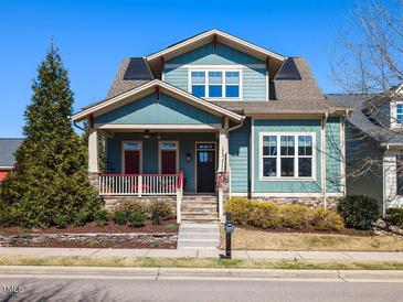 Charming two-story home featuring a welcoming front porch, well-maintained landscaping, and stone accents at 1980 Great Ridge Pkwy, Chapel Hill, NC 27516