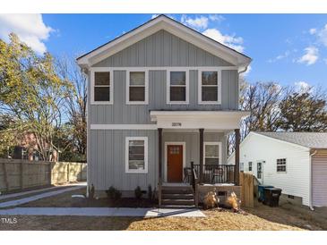 Charming two-story home featuring a welcoming front porch and light gray siding at 2207 Otis St # B, Durham, NC 27707