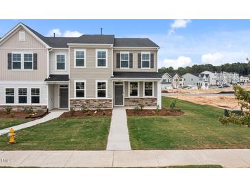 Charming new construction townhomes with manicured lawns and stone accents in a desirable community at 2313 Kasota Ln, Raleigh, NC 27610