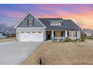 Charming single-Gathering home with a two-car garage and a well-maintained front yard under a colorful sky at 241 N Nolan Park Dr, Selma, NC 27576