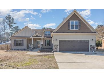 Charming two-story home featuring a two-car garage, landscaped yard and inviting front porch at 2440 Us 70 A, Selma, NC 27576