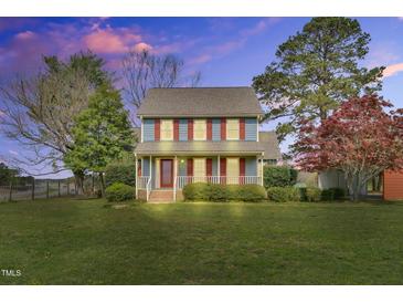 Charming two-story home featuring blue siding, red shutters and a cozy front porch at 3808 Johnson Pond Rd, Apex, NC 27539