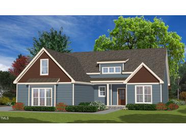 Charming one-story home with blue siding, brown shingles, and beautifully landscaped front yard at 390 Pilot Ridge Rd, Zebulon, NC 27597