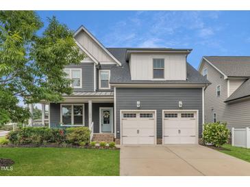 Charming two-story home with a two-car garage, covered porch, and beautifully landscaped front yard at 706 Fireball Ct, Knightdale, NC 27545