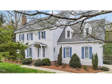 Charming two-story home with white siding, blue shutters, and a well-manicured front yard at 7201 Jonathan Dr, Wendell, NC 27591