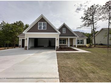 Beautiful two-story home featuring a large driveway, attached garage, and inviting front porch at 104 Roma Gora Ct, Princeton, NC 27569