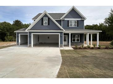Beautiful two-story home with a three car garage, covered porch, and charming curb appeal at 106 Roma Gora Ct, Princeton, NC 27569