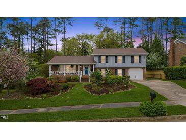 Charming two-story home featuring well-maintained landscaping and a welcoming front porch at 1205 Country Ridge Dr, Raleigh, NC 27609