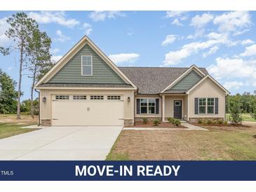 Charming single-Gathering home featuring a two-car garage, neutral siding, and manicured landscaping at 125 Prosecco Dr, Princeton, NC 27569