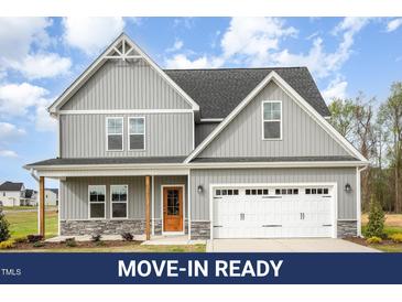 Beautiful two-story home featuring gray siding, a stone-accented foundation, and an attached two-car garage at 15 Lupin Dr, Smithfield, NC 27577