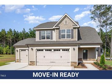 Charming two-story home with a three-car garage and well-maintained landscaping at 18 Bonnybrook Ct, Selma, NC 27576