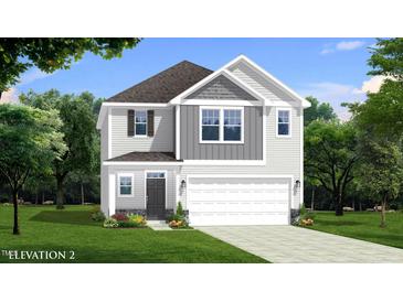 Two story home featuring board and batten siding, a gray shingle roof and an attached two car garage at 2011 Cross Bones Blvd # 41, Durham, NC 27703