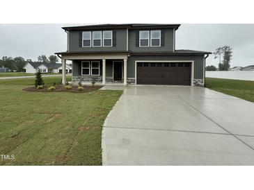 Charming two-story home with attached garage and a well-manicured lawn at 212 Tuscany Cir, Princeton, NC 27569