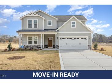 Charming two-story home with a two car garage and beautifully maintained front yard at 231 Trescott St, Smithfield, NC 27577