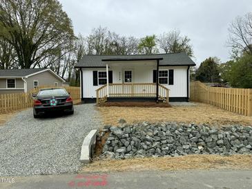 Charming cottage-style home with a cozy front porch, fresh landscaping, and a newly graveled driveway at 2316 Radiance Dr, Burlington, NC 27215