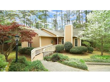 Charming home featuring a ramp, chimney, and lush landscaping at 2765 Rue Sans Famille, Raleigh, NC 27607
