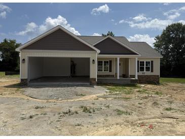 Charming single-story home featuring a large, attached two-car garage and inviting front porch at 28 Bailey-Boykin Rd, Selma, NC 27576