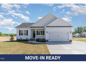 Charming one-story home features a white exterior, black shutters, and an attached two-car garage at 30 Tee Dr, Selma, NC 27576