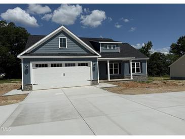Charming new construction featuring a two-car garage and stylish gray siding at 40 Bailey-Boykin Rd, Selma, NC 27576