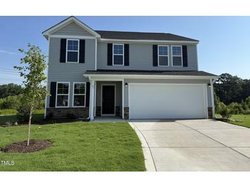 Charming two-story home with gray siding, a two-car garage, and a well-manicured lawn at 43 Chloe Ct, Selma, NC 27576