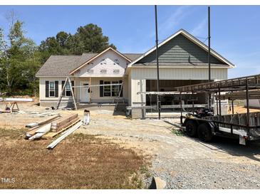 Under-construction single story home featuring light siding and a two car garage at 47 Royal Ave, Selma, NC 27576