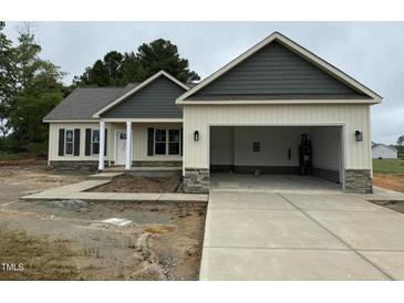 Charming, single-story home with a two-car garage, stone accents, and covered front porch at 47 Royal Ave, Selma, NC 27576
