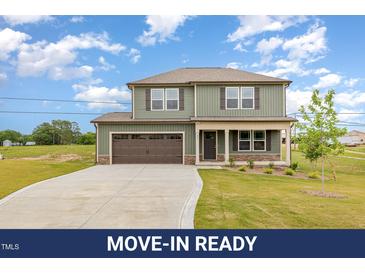 Inviting two-story home featuring a spacious driveway and attached two car garage at 48 Silver Ct, Smithfield, NC 27577
