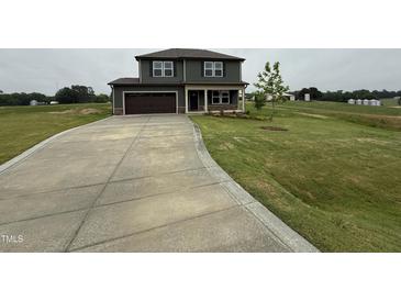 A charming two-story home with an attached garage and long driveway at 48 Silver Ct, Smithfield, NC 27577